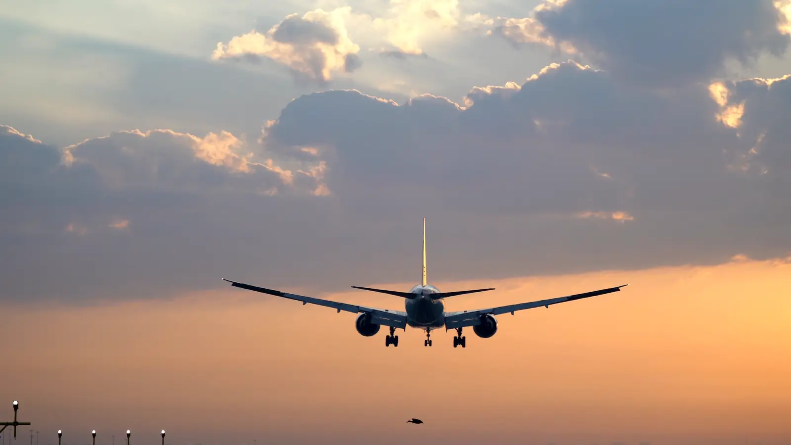 An aircraft taking off at sunset
